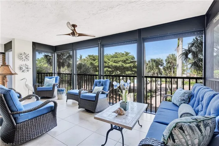 Featuring plenty of natural light, a textured ceiling, floor to ceiling windows, and tile patterned floors