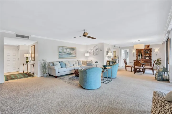Great room with coastal tones and crown molding