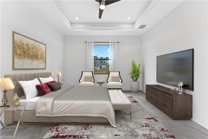 Bedroom with light carpet, tray ceiling, and ceiling fan - photo enhanced with virtual staging.