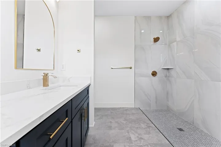 Bathroom featuring a shower and vanity