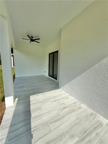 Wooden terrace featuring a ceiling fan