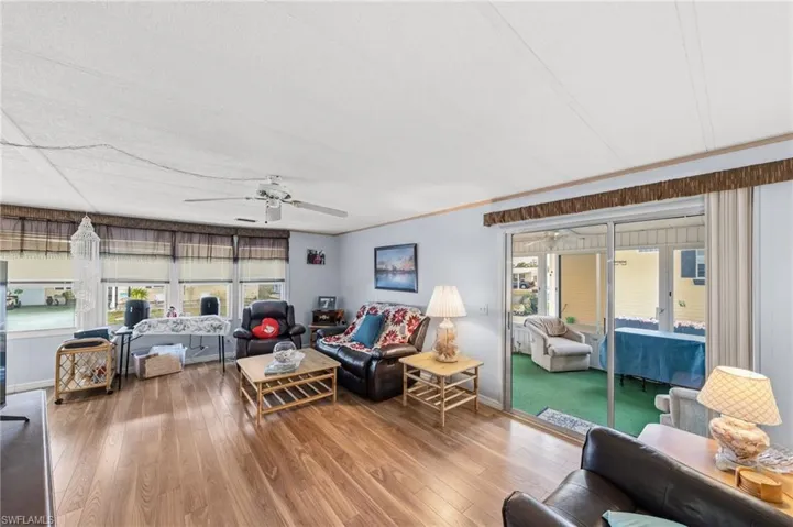 Living area featuring ceiling fan, hardwood / wood-style floors, and healthy amount of natural light