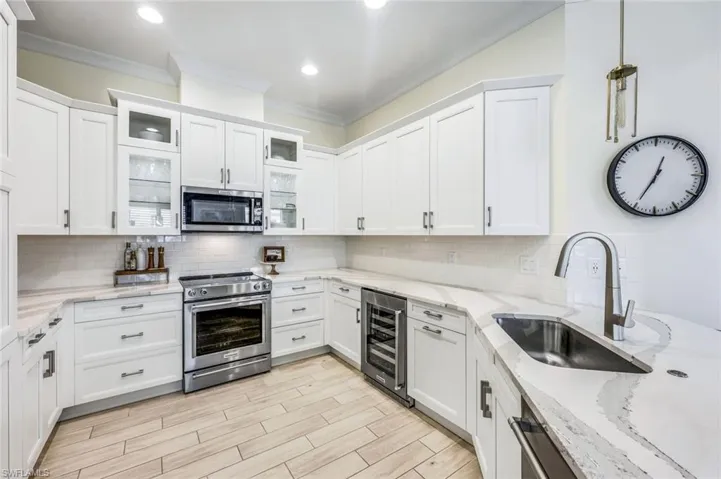 Kitchen featuring wine fridge, upgraded cabinets and appliances