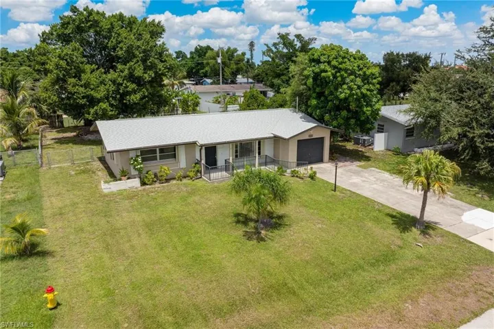 Ranch-style home with a garage, covered porch, and a front yard
