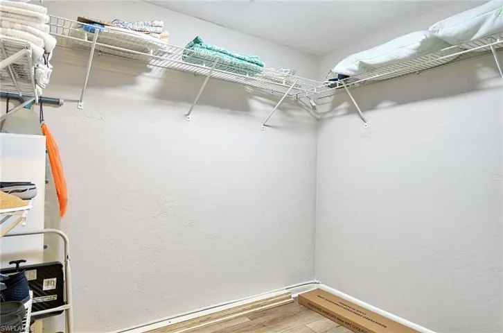 Primary Walk in closet featuring Luxury Vinyl flooring