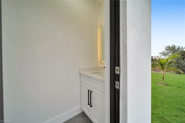 Bathroom featuring vanity and dark tile patterned flooring