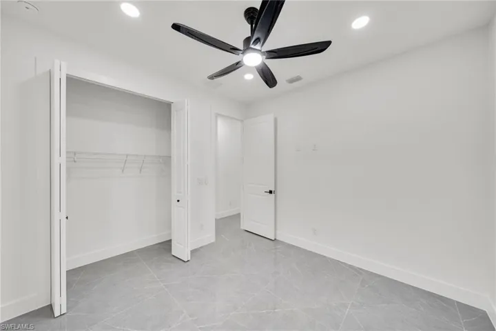 Unfurnished bedroom with ceiling fan, recessed lighting, and a closet