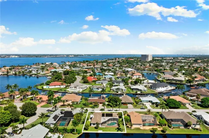 Aerial perspective of suburban area with a large body of water