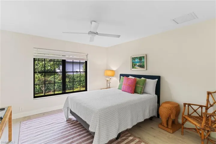 Bedroom featuring wood finished floors and a ceiling fan