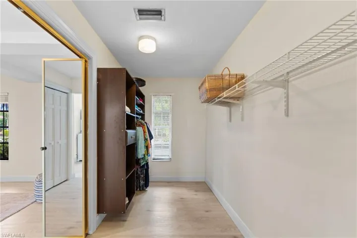 Walk in closet featuring light wood-style floors