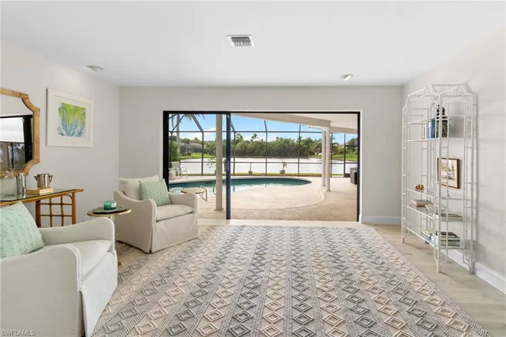 Living area with a sunroom and light wood-type flooring