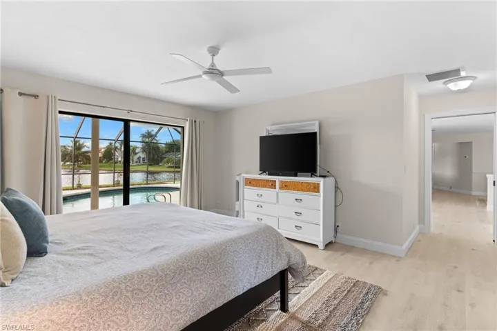 Bedroom featuring light wood-type flooring, a ceiling fan, and access to exterior