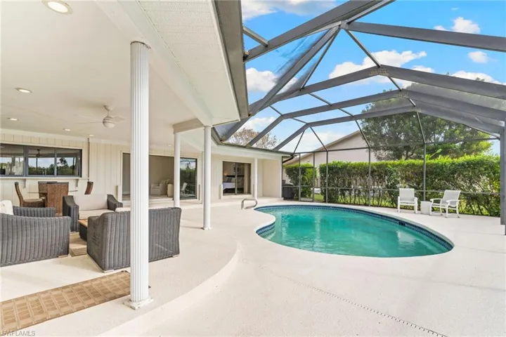Outdoor pool featuring a patio, a sunroom, a lanai, and outdoor lounge area