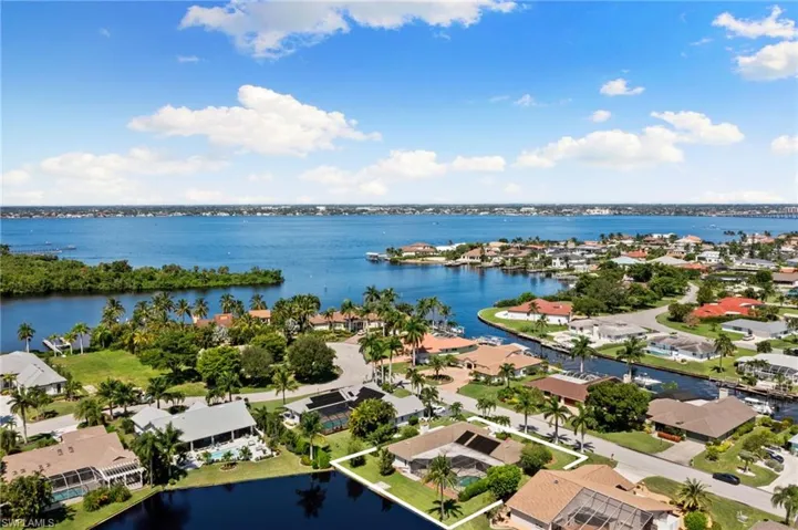Aerial perspective of suburban area featuring a large body of water