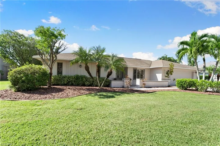 Single story home featuring a front lawn and a garage