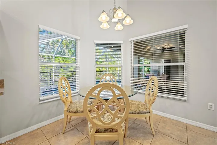 Dining area with a chandelier and tile patterned floors