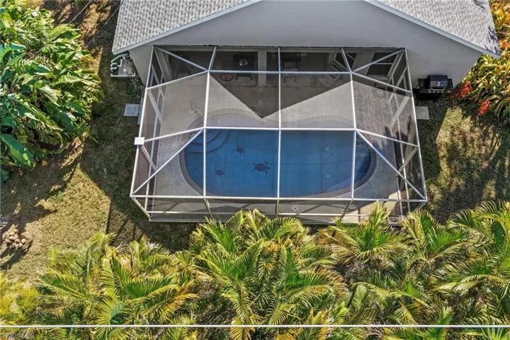 View of swimming pool featuring a sunroom and a lanai