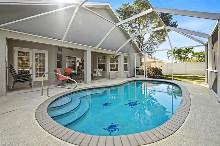 View of swimming pool with a patio area, a sunroom, a lanai, french doors, and grilling area