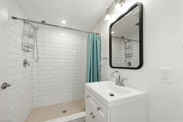 Bathroom featuring vanity, a shower stall, and recessed lighting