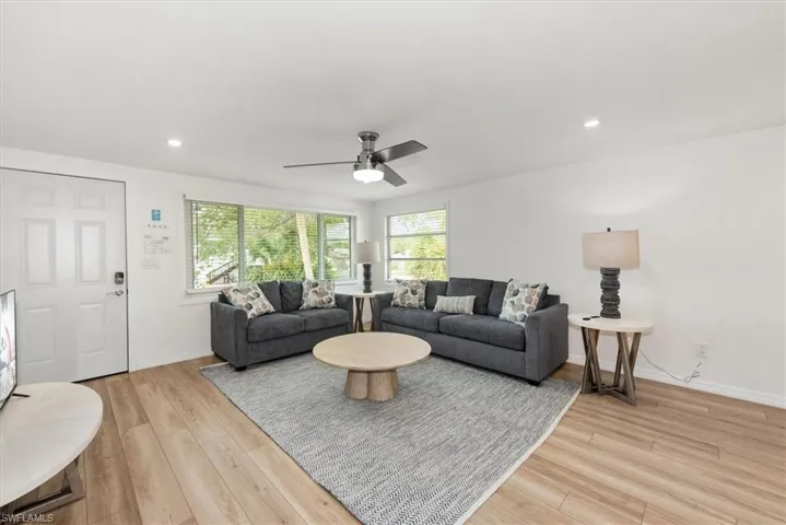 Living area featuring light wood-style flooring, recessed lighting, and ceiling fan