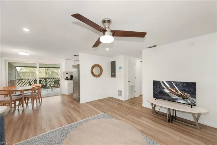 Living area featuring recessed lighting, light wood-type flooring, a ceiling fan, and electric panel