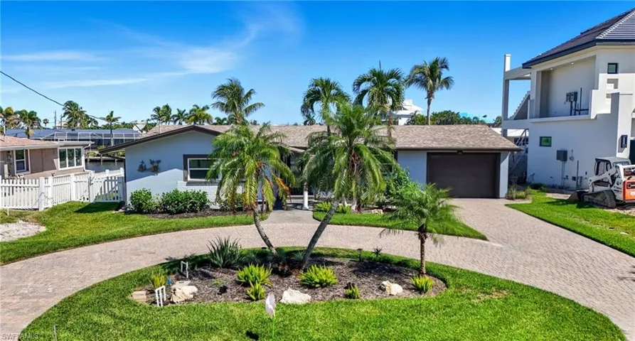 View of front of property featuring decorative driveway, stucco siding, an attached garage, and roof with shingles - Virtually Edited Image