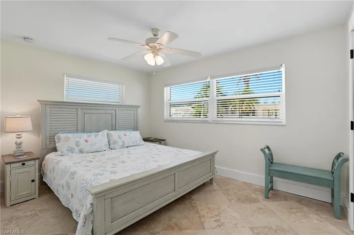 Bedroom with a ceiling fan and baseboards - Virtually Edited Image