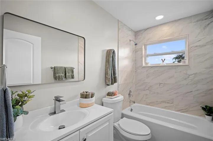 Bathroom featuring a single vanity with white cabinetry, a rectangular basin, and a modern chrome faucet