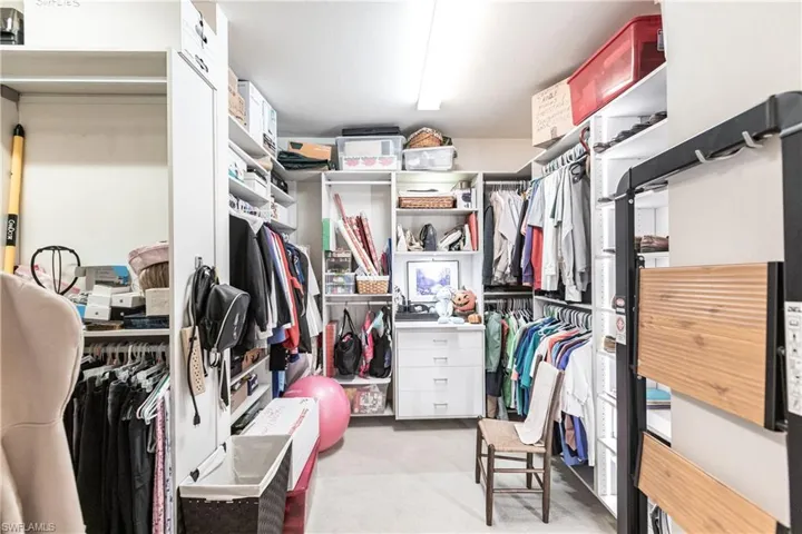 Walk in closet with light carpet