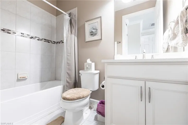 Full bathroom featuring vanity, tile patterned floors, toilet, and shower / bath combo