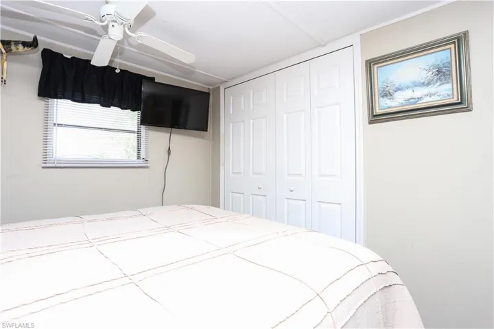 Bedroom featuring ceiling fan and a closet