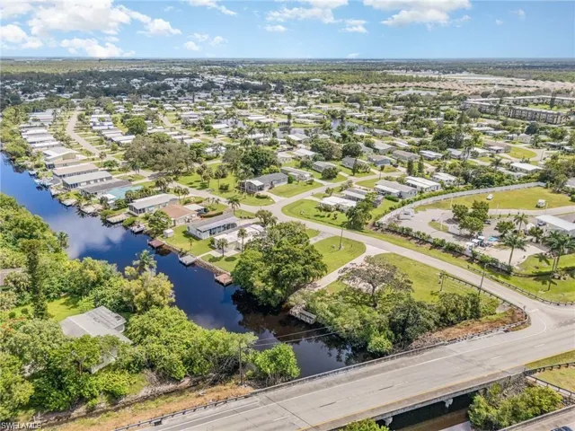 Aerial perspective of suburban area featuring a large body of water