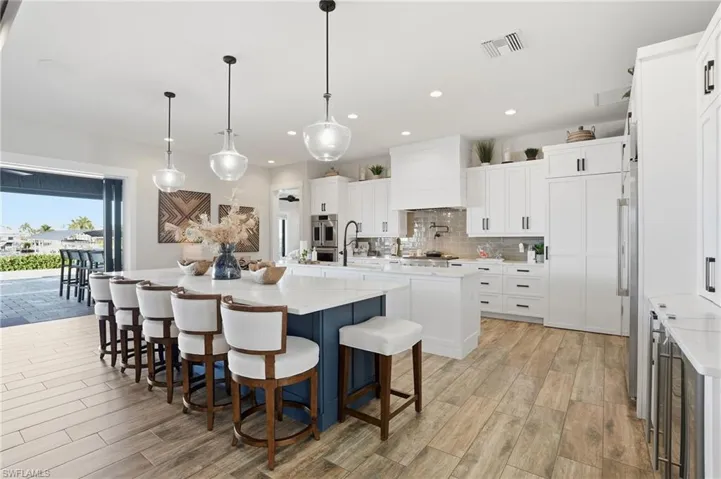 Kitchen with custom cabinets and dual islands