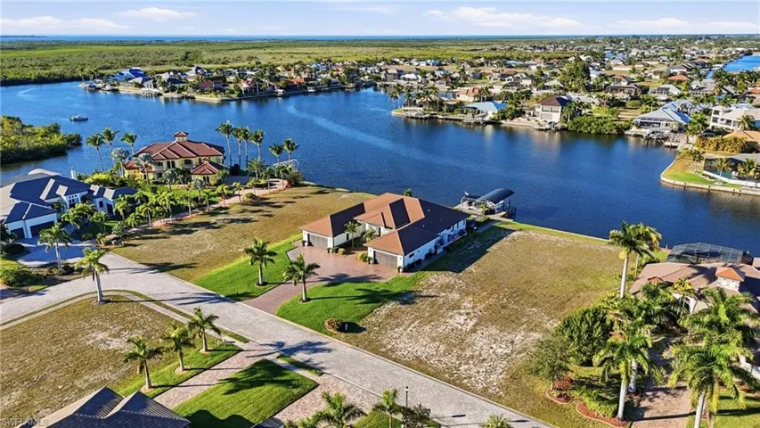 Aerial view of residential area featuring a nearby body of water