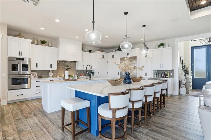 Kitchen with custom cabinets, dual islands and coffee bar