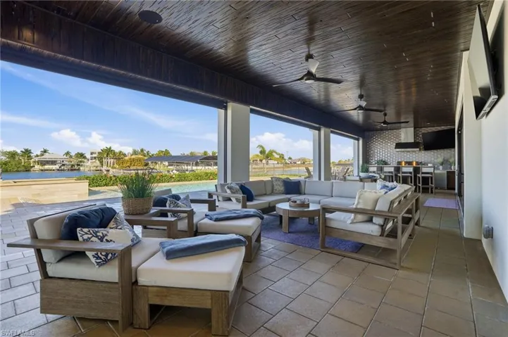 View of patio / terrace featuring cypress wood ceilings, a water view, and outdoor lounge area