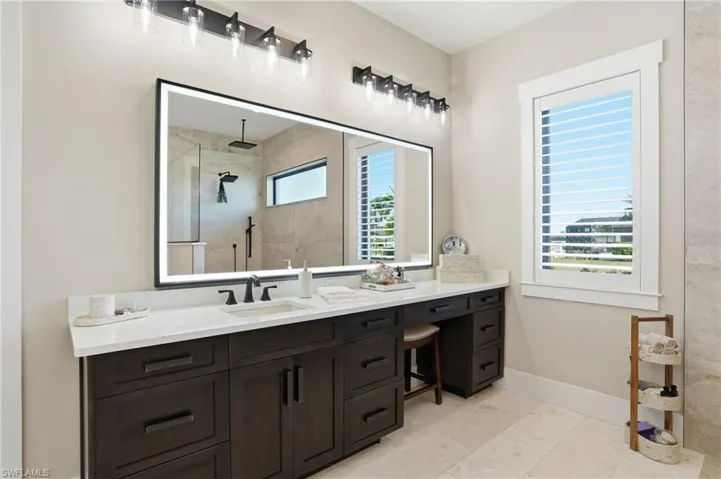 Primary bathroom with custom cabinets with outlets inside drawers and vanity area