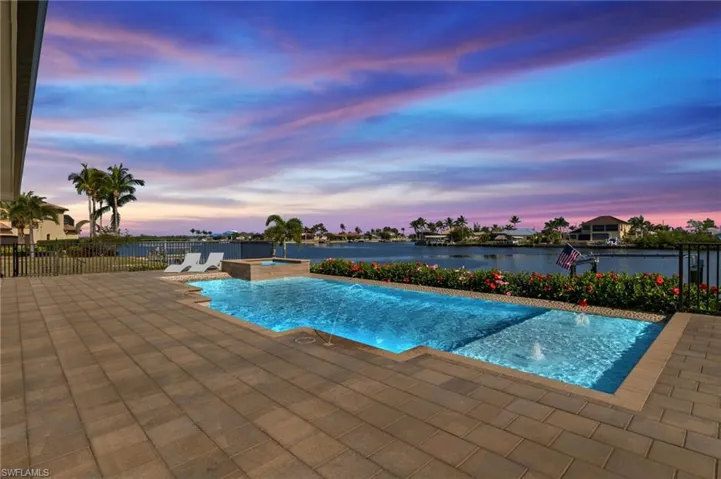 View of pool with a pool with connected hot tub and a patio area