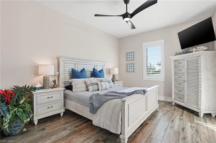 Bedroom featuring dark wood-style floors and a ceiling fan