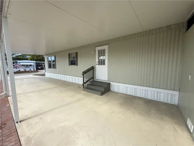 View of patio featuring entry steps and an attached carport