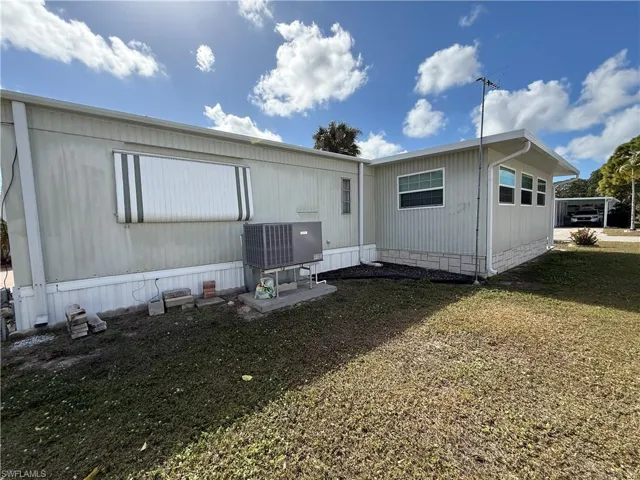 Back of property featuring a lawn