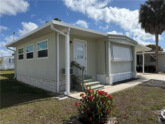 View of side of property featuring a yard