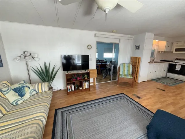 Living area featuring a ceiling fan and light wood-style flooring