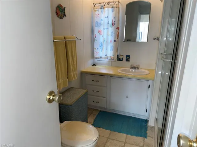 Bathroom with vanity and a shower with shower door
