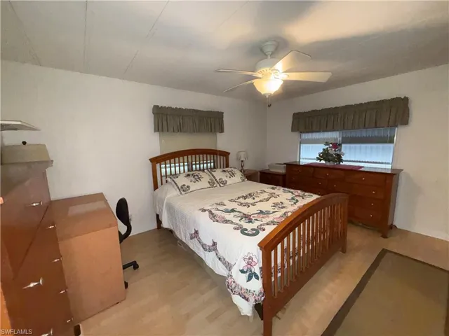 Bedroom with light wood-style flooring and a ceiling fan