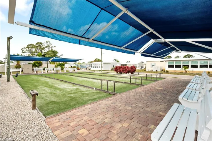 Surrounding community featuring a game area, a patio, and a residential view