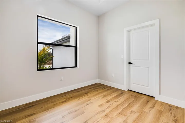 Unfurnished room with baseboards and light wood-style flooring