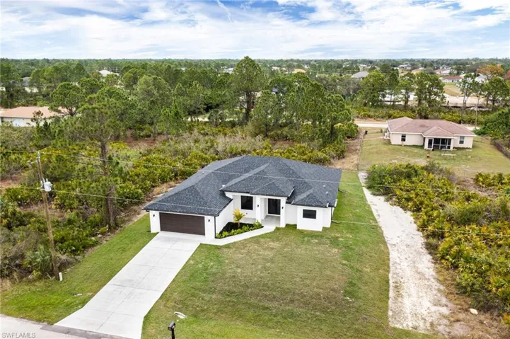 Aerial view of residential area featuring a tree filled landscape