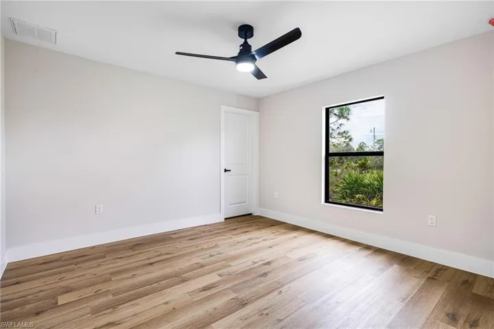 Spare room featuring light wood finished floors and ceiling fan