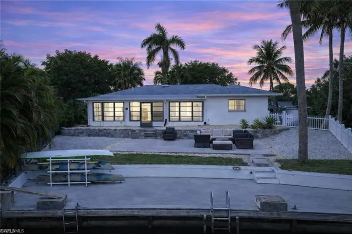 Back of house with an outdoor living space and a patio area
